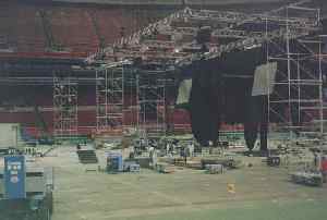 (Photo: a few 
hours later. Cliffs of scaffolding; huge video screens are being hoisted 
into position)